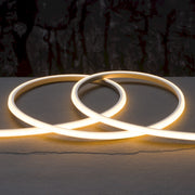 Warm white LED neon strip light forming two interlocking curved loops