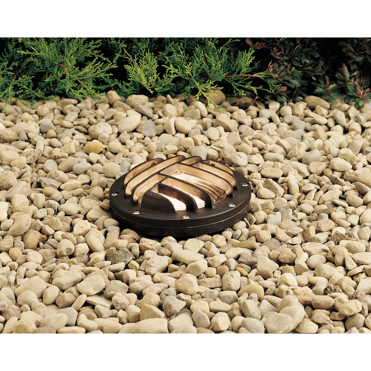 Architectural bronze circular rock guard with curved metal openings