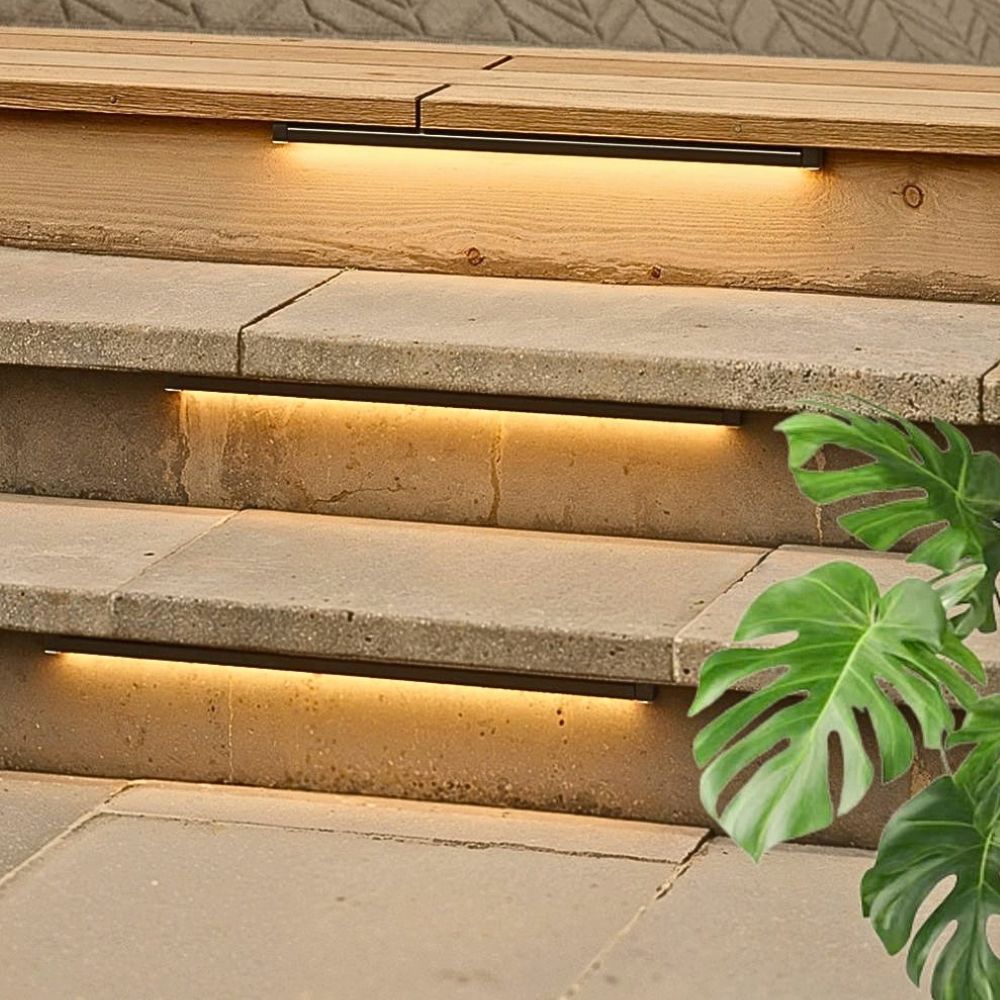 Warm-white LED hardscape lights illuminating stone steps along a walkway