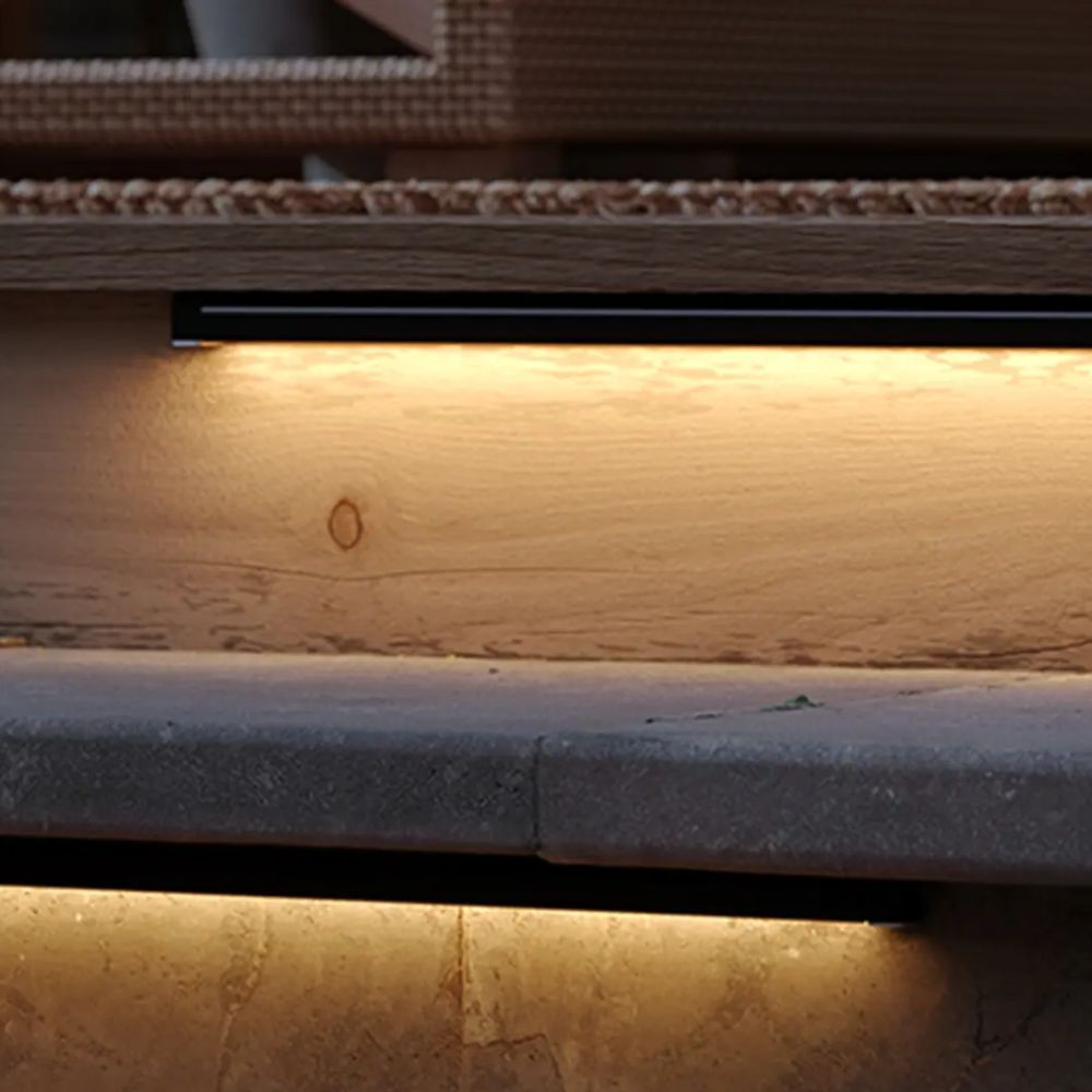 Warm glow from a hardscape LED light under an exterior ledge