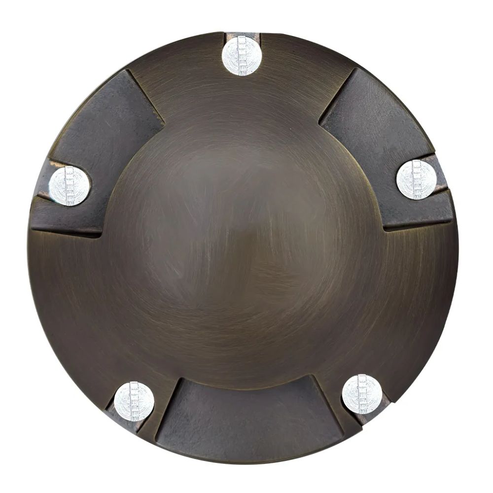 Top view of tri-directional LED well light with circular brass face and four mounting bolts