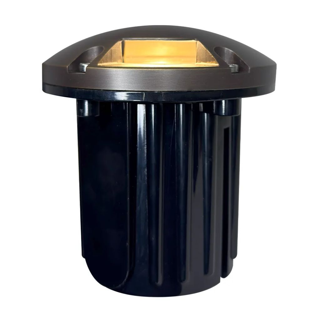 Tri-directional LED well light with warm-lit brass reflector opening and black base
