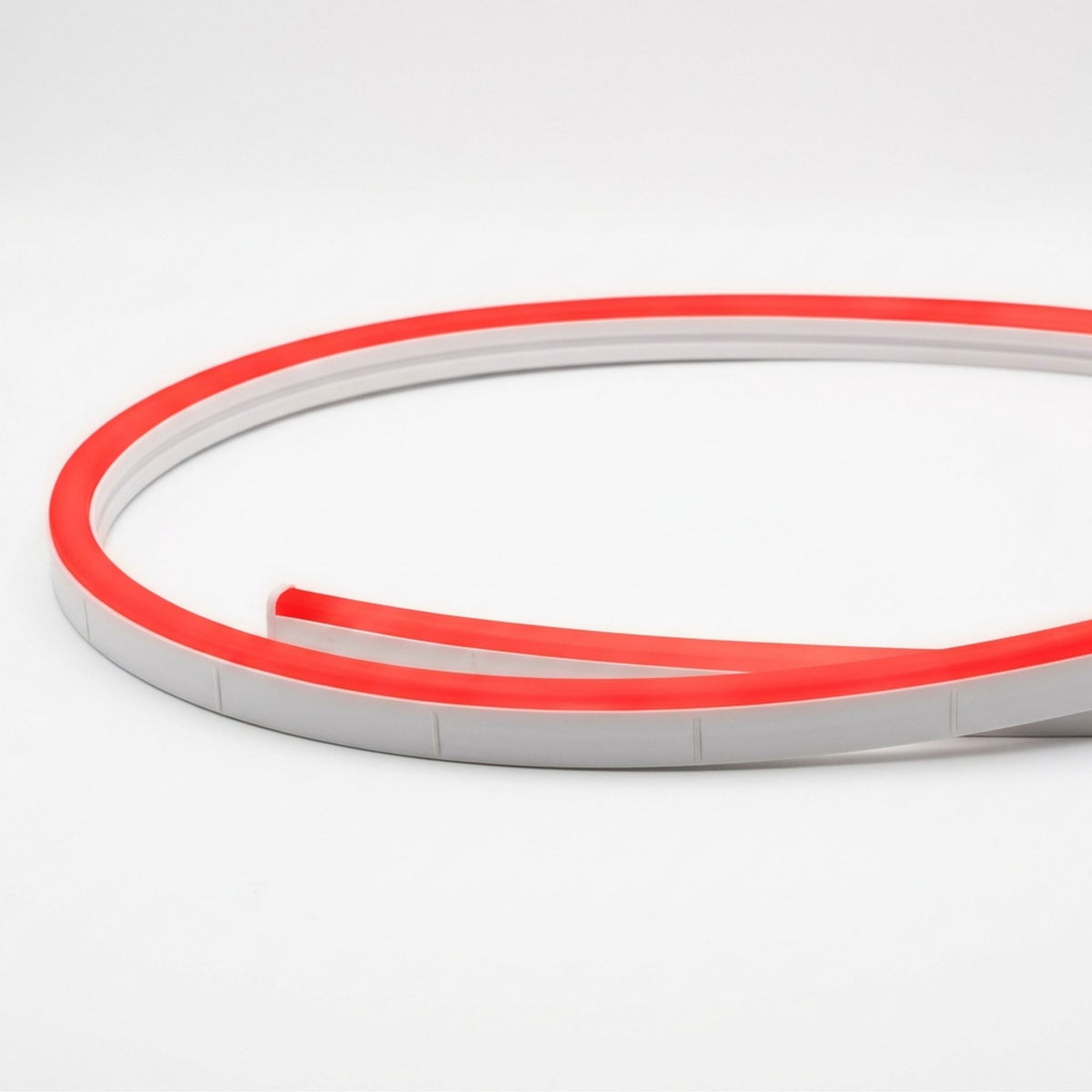 Red neon linear light with gray channel and glowing tube at a curved corner