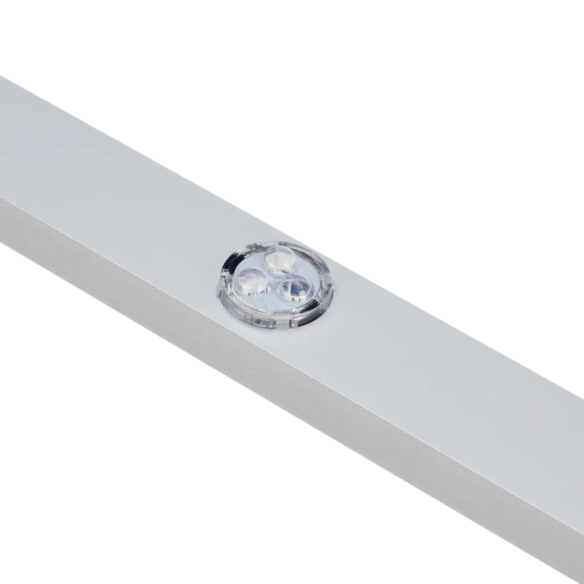 Clear LED puck seated in a circular opening on a gray aluminum lighting channel