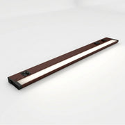 Bronze undercabinet LED light bar with two built-in outlets and dark end caps.