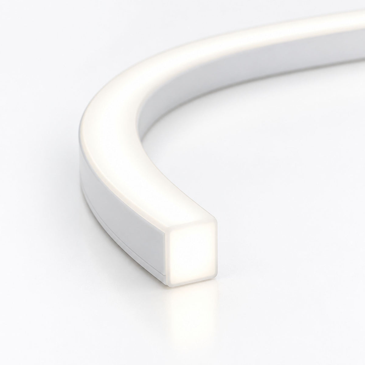 White curved end section of 6x6 top-bend LED neon strip with glowing light.