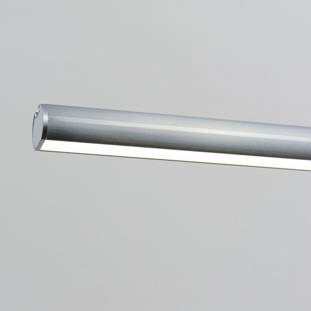 Satin aluminum pendant light with cylindrical metal housing, open end visible