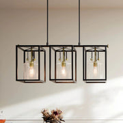 3-light chandelier with three black cage shades and clear seeded glass, natural brass details
