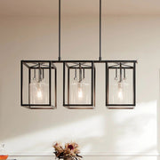 Three-light black cage chandelier with clear glass shades and exposed bulbs