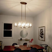 Brushed brass 8-light chandelier with clear cylindrical shades and hanging arms