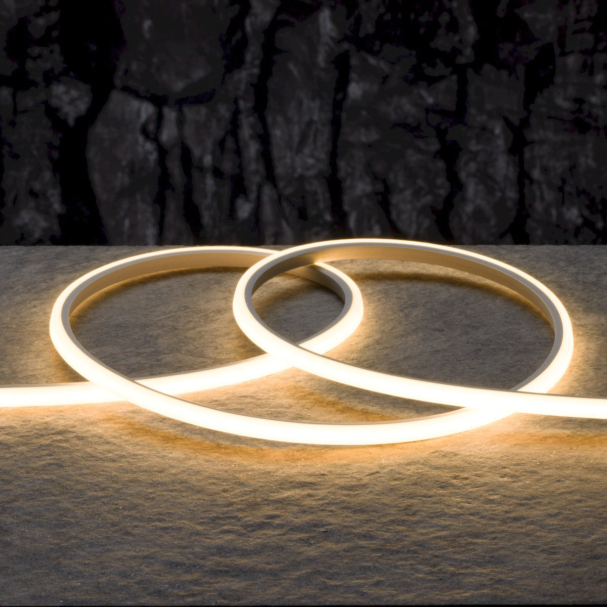 Soft white LED neon strip with two overlapping loop shapes on a surface