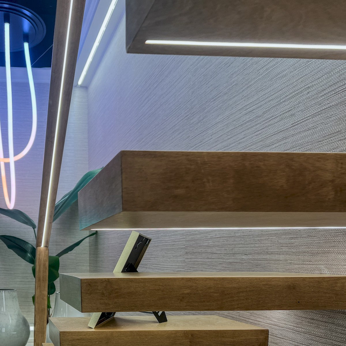 Warm white LED neon strip mounted along stair edge under a ledge