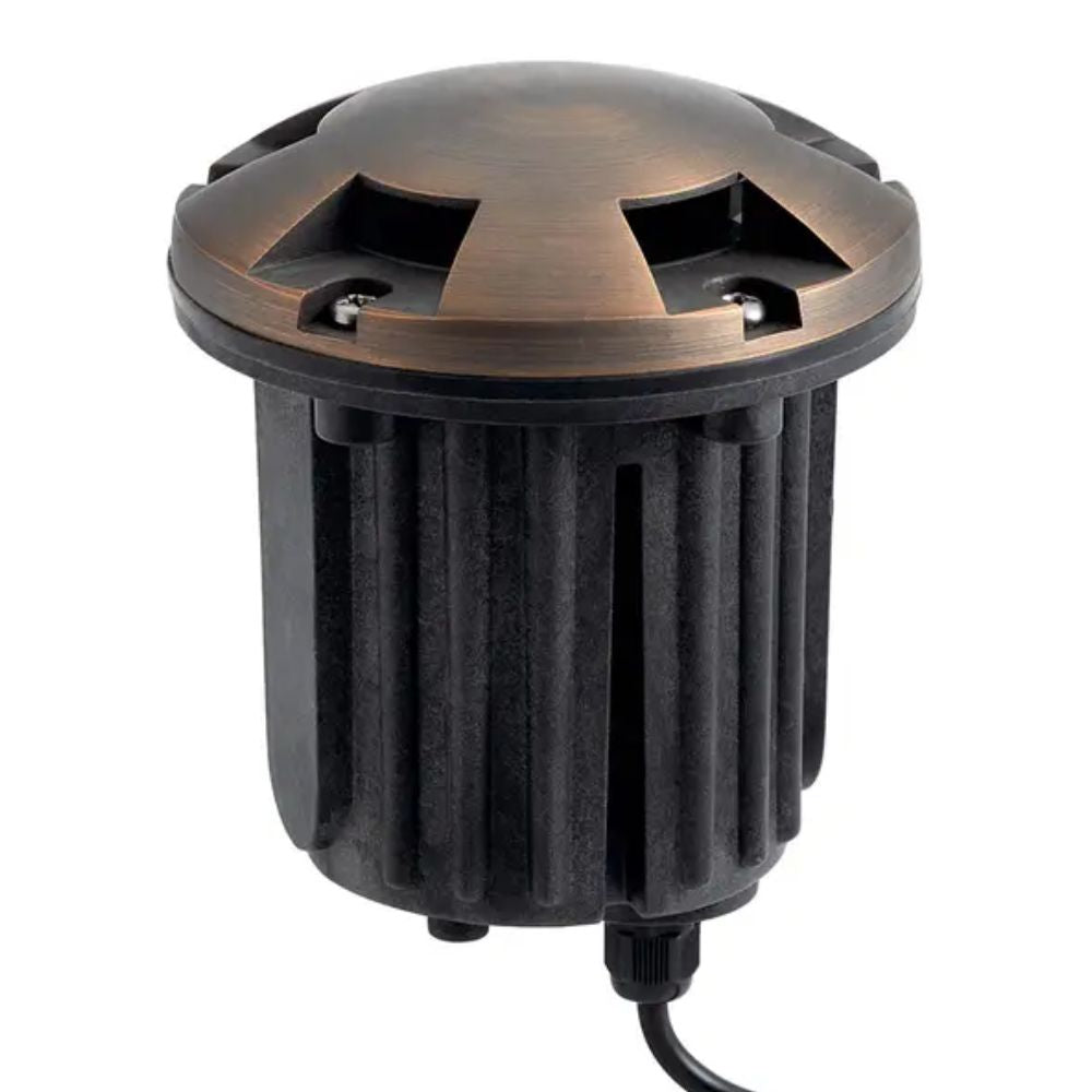 Brass in-ground landscape beacon light with ribbed black housing and power cable