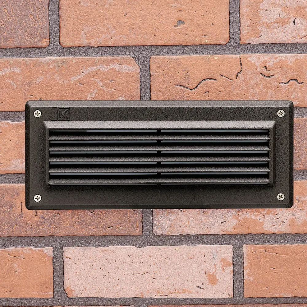 Bronze LED landscape step light with rectangular louver face and mounting screws