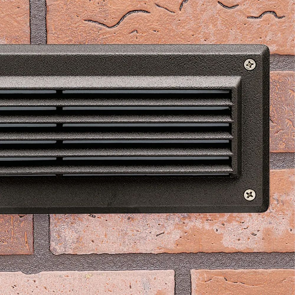 Textured bronze LED step light with front grille and mounting screws