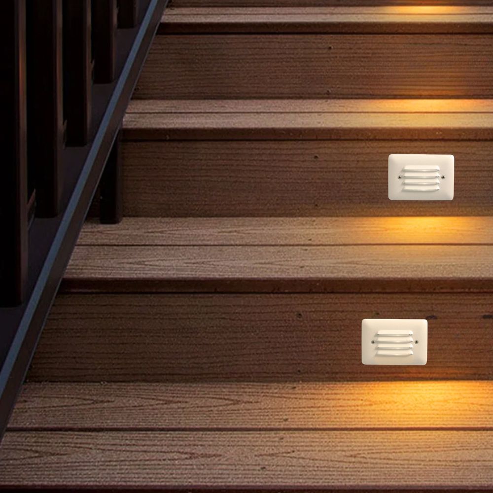 Warm white louvered LED step lights installed on wooden stairs