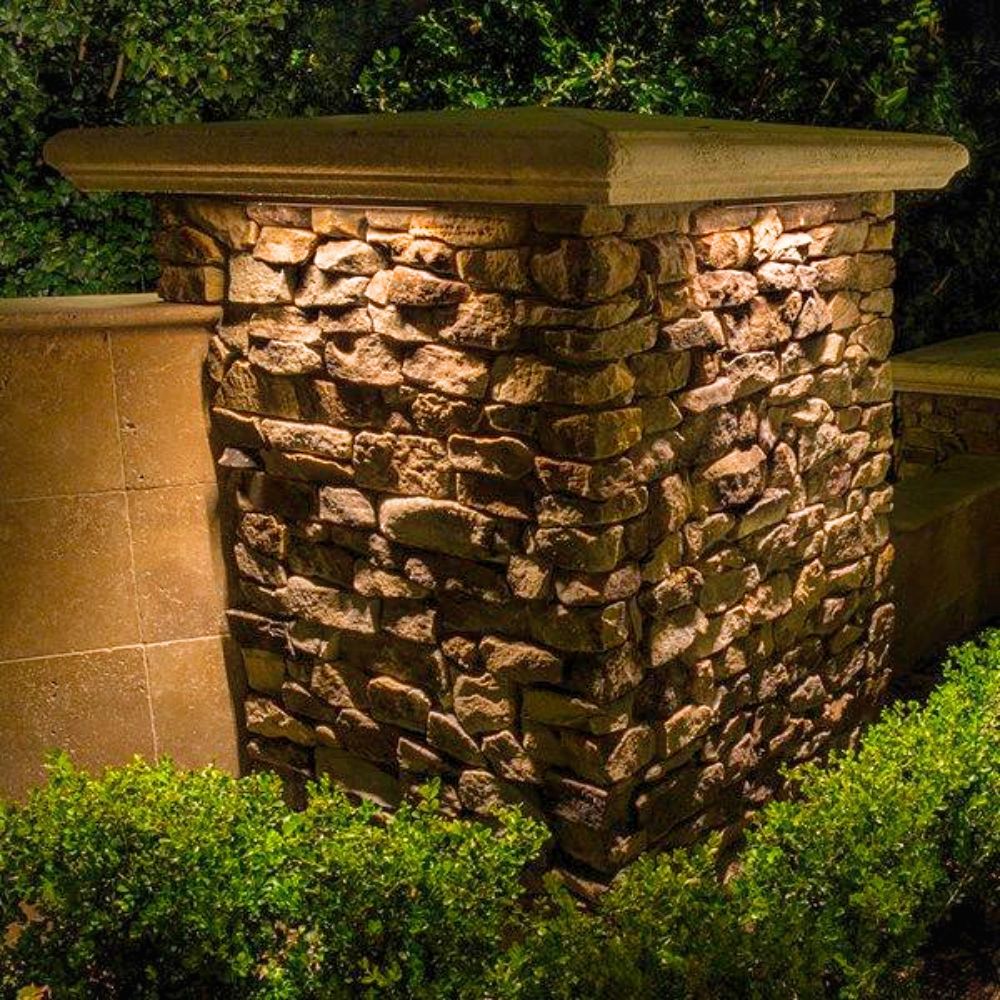 Warm glowing LED hardscape light mounted on stone wall fixture