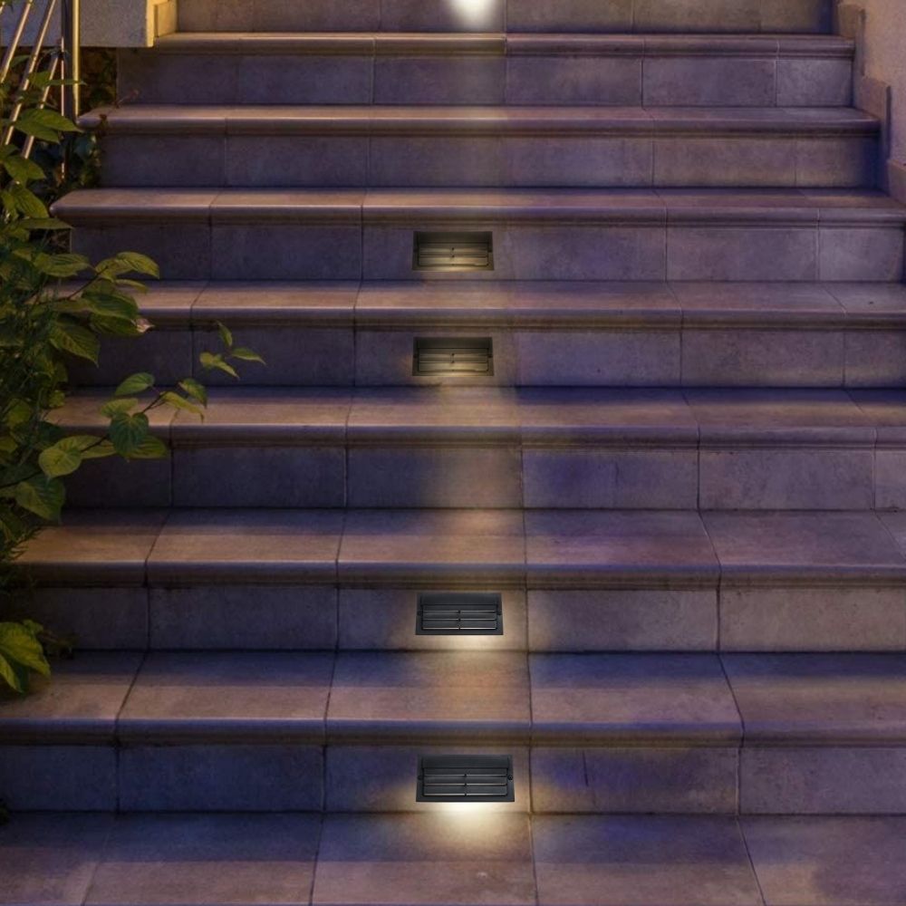 Outdoor LED step lights set into stone stair treads with warm illumination