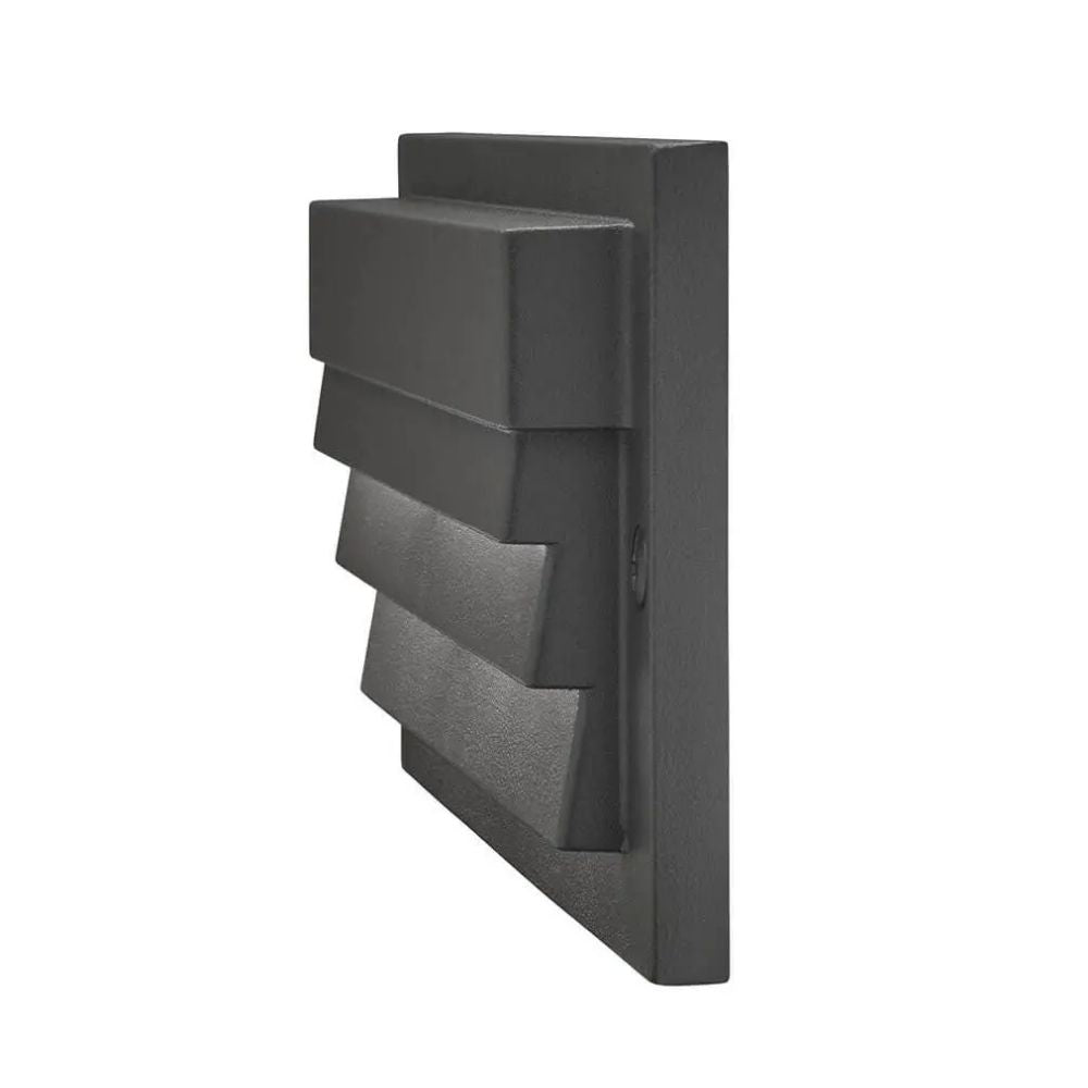 Textured black louvered LED step light with angled housing and rectangular grille
