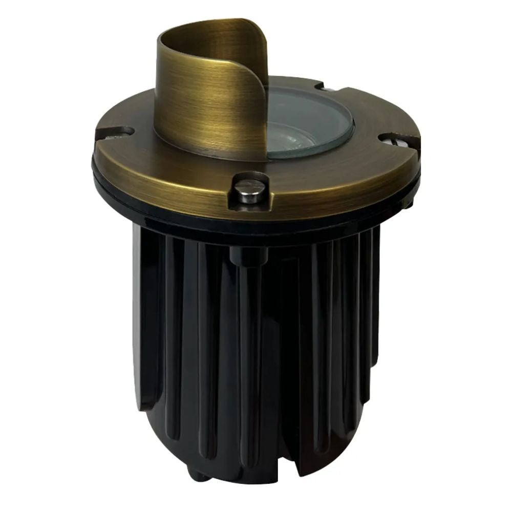 LED well light with natural brass trim and black ribbed housing, clear lens on top