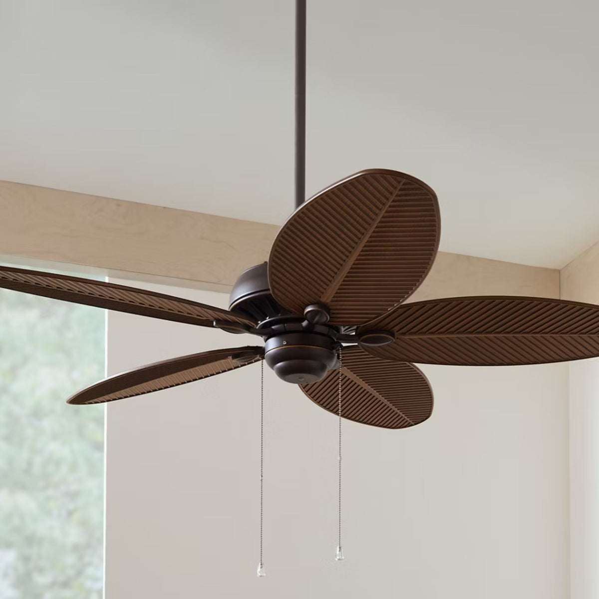 Outdoor ceiling fan with dark housing and five brown wood-style blades