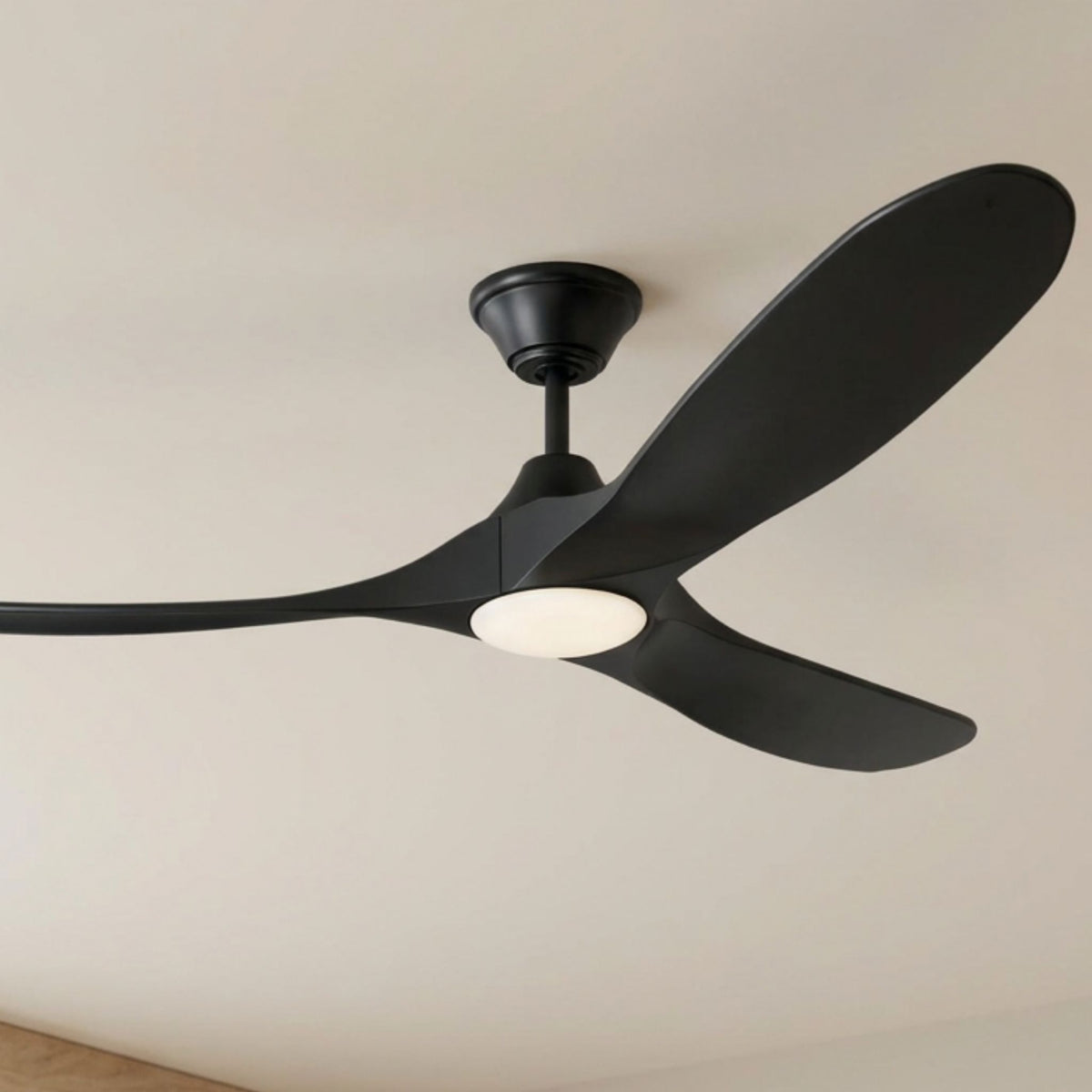 Close-up of matte black LED ceiling fan hub, three dark blades, and round light