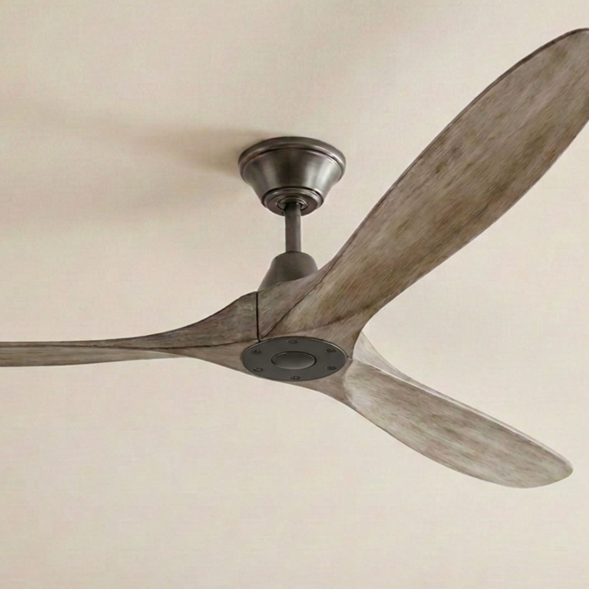 Ceiling fan close-up with weathered oak blades and aged pewter motor housing