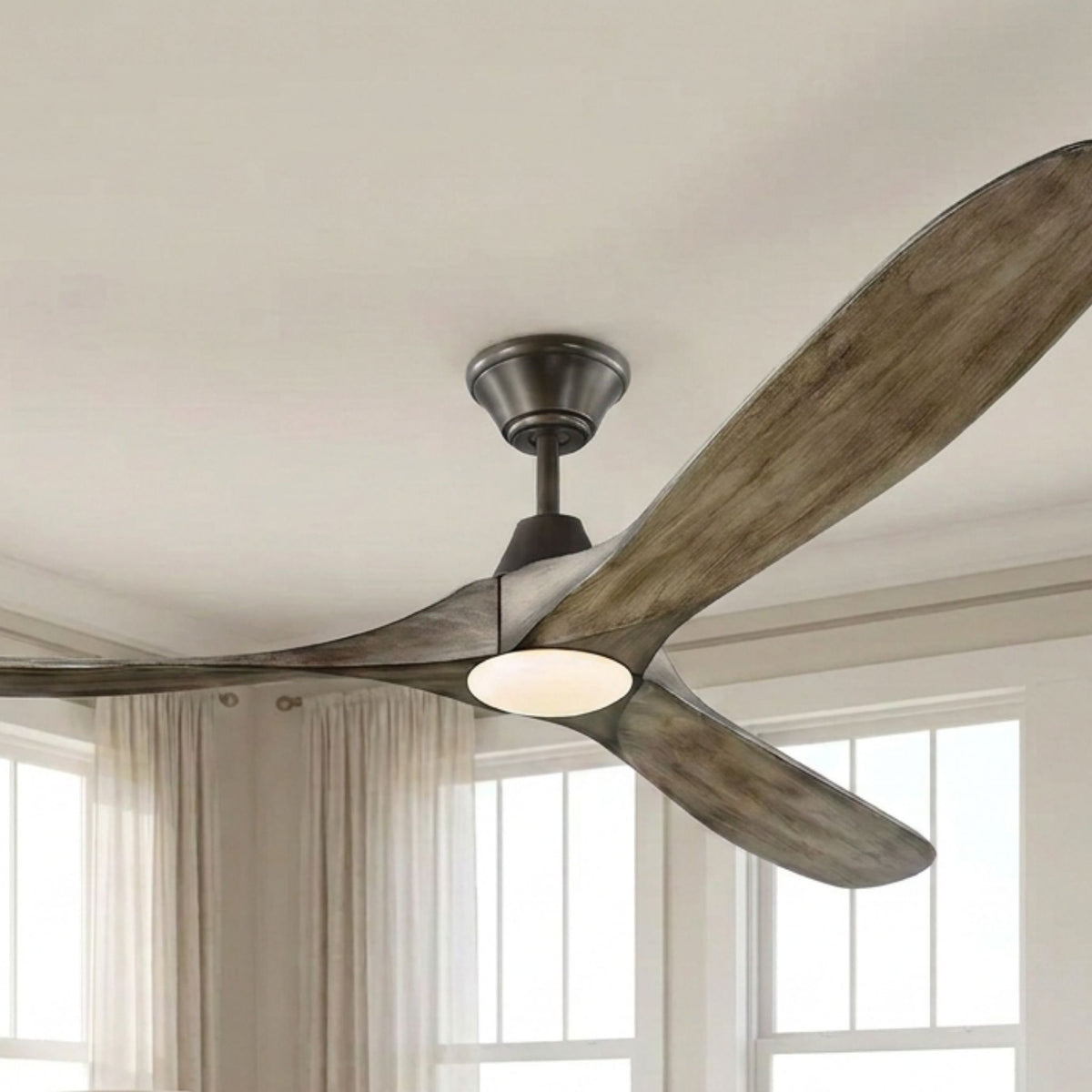 Ceiling fan in aged pewter with weathered oak blades and frosted LED light, angled view