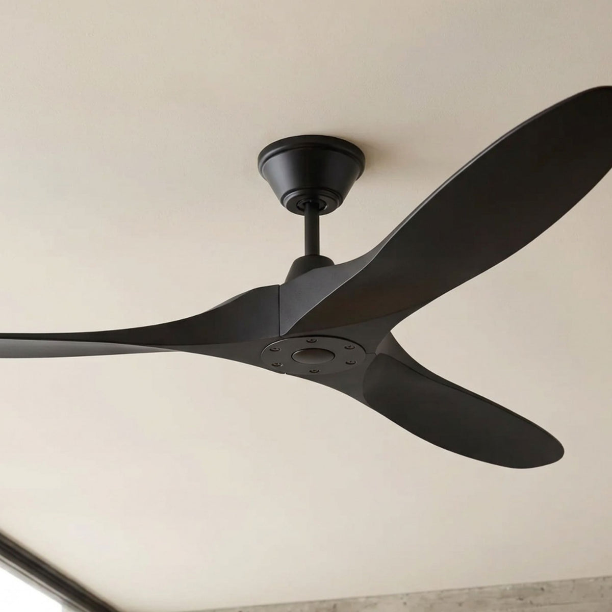 Matte black ceiling fan with three blades and central motor housing.