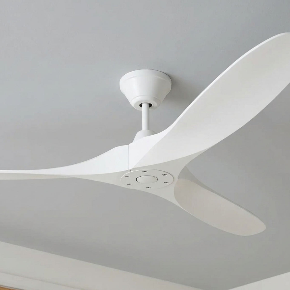 Matte white ceiling fan with four wide blades on a downrod