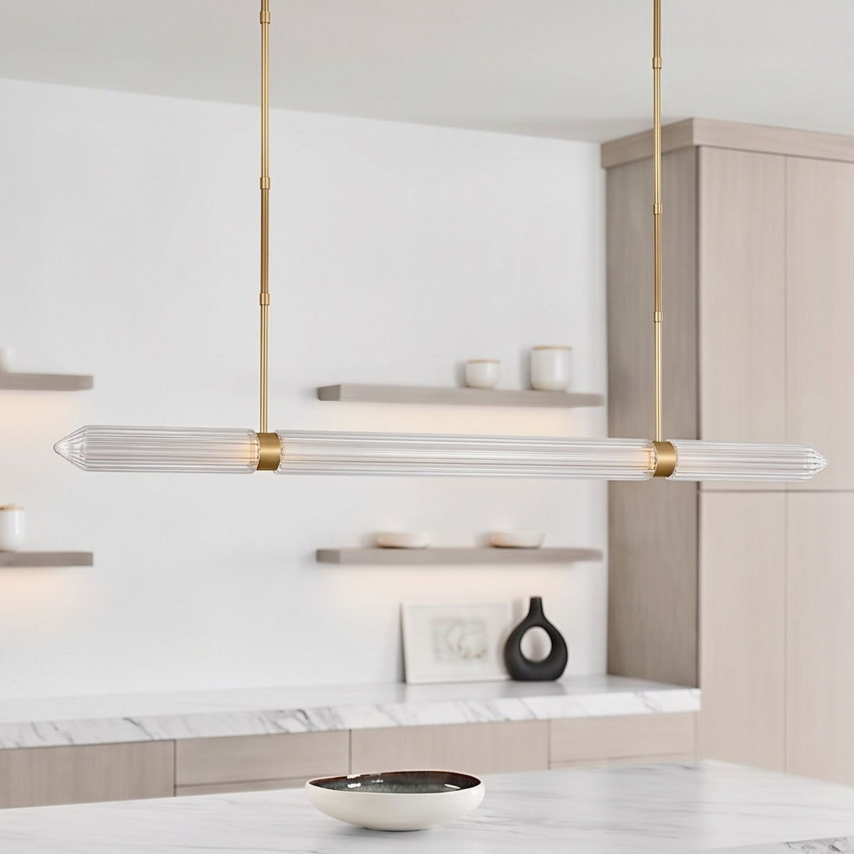 Suspended linear LED chandelier with plated brass stems and clear ribbed glass