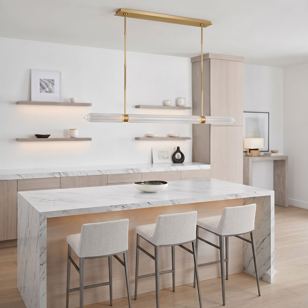 Linear LED chandelier featuring plated brass canopy and clear ribbed glass shades